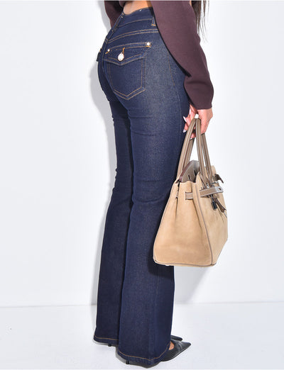 Jeans flare taille basse à poches boutons strass à l'arrière