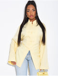 Blouse col montant à attaches qui se noue dans le dos