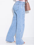 Jeans coupe large taille moyenne à coutures effilochées