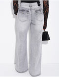 Jeans taille basse wide leg à poches rabattues