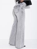 Jeans taille basse wide leg à poches rabattues