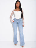 Jeans taille basse flare à broderies sur les poches