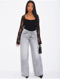 Jeans taille basse wide leg à poches rabattues