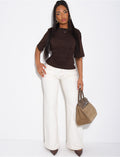 Jeans taille basse wide leg à poches rabattues