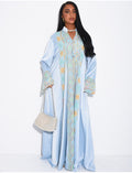 Abaya en satin à empiècements brodés et pompons